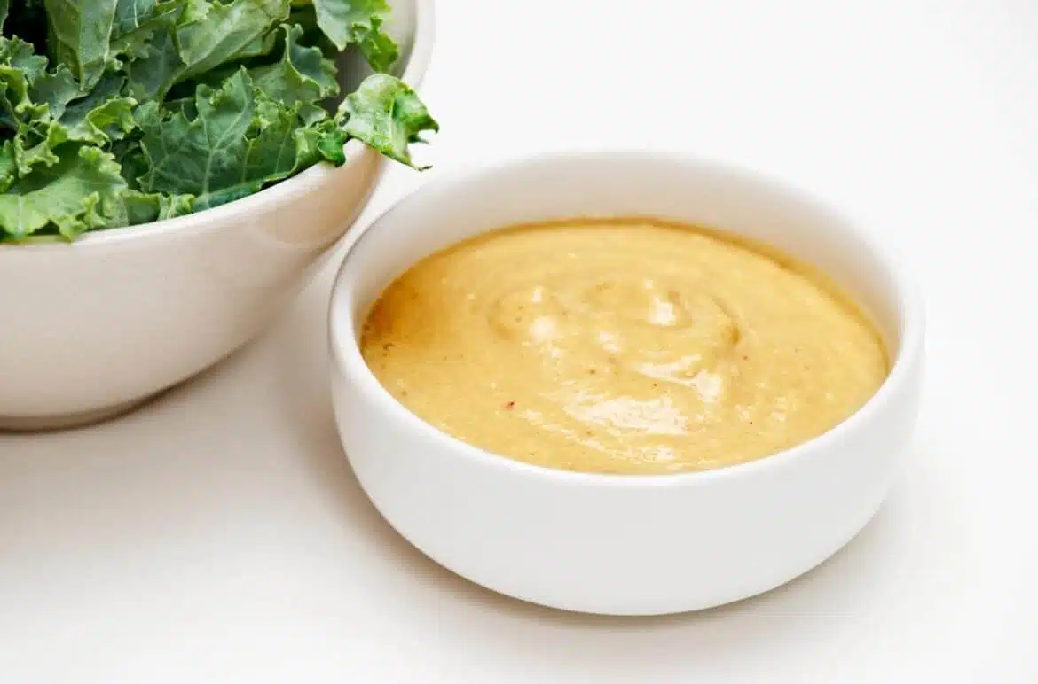 Healthy And Sugar-Free Tangy Salad Dressing With A Bowl Of Lettuce