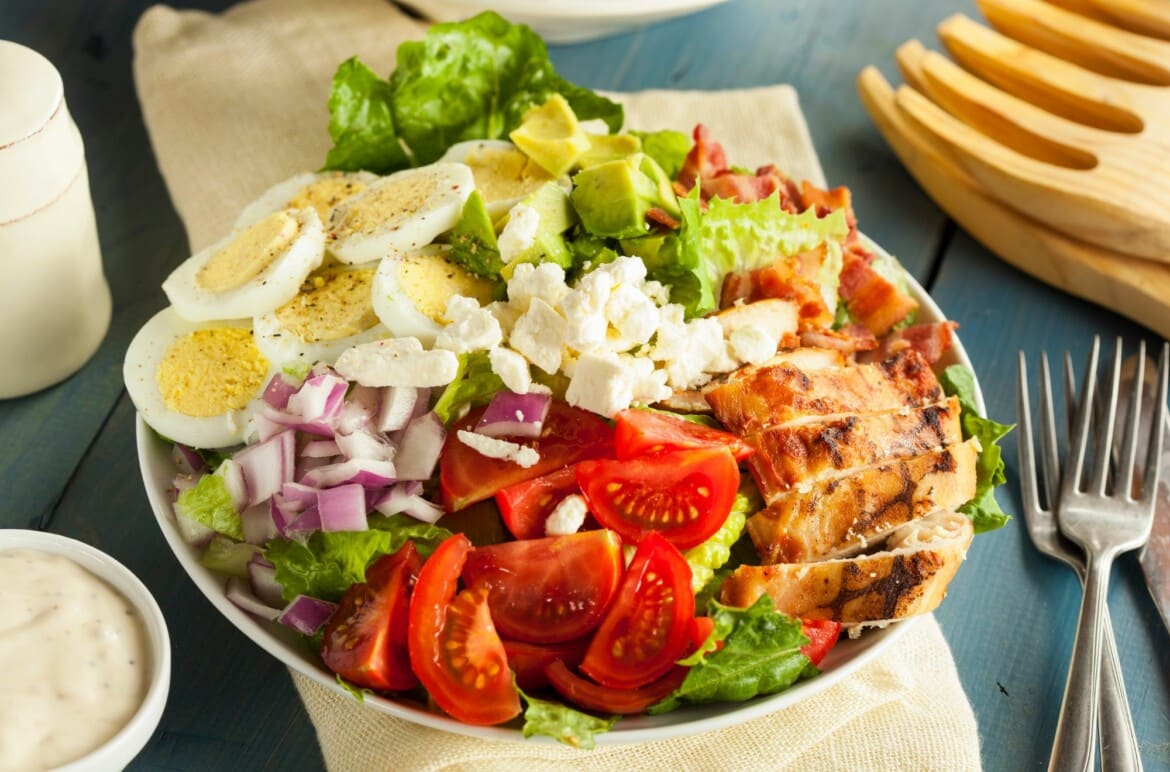 Delicious Grilled Chicken and Bacon Salad with Creamy Italian Dressing In A White Serving Bowl